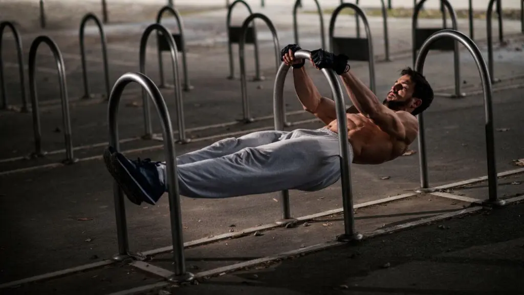 Man does a front lever calisthenics exercise outside