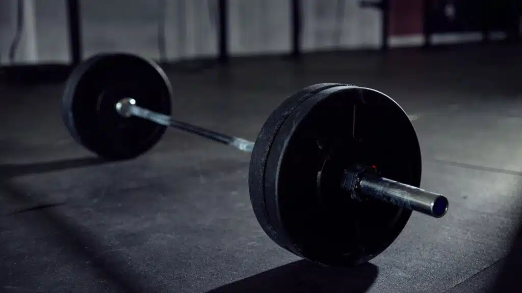 Loaded barbell lying on the floor gym.