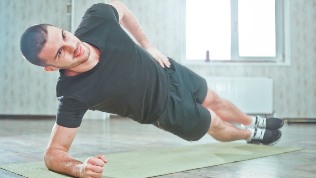 man doing side plank on his right elbow