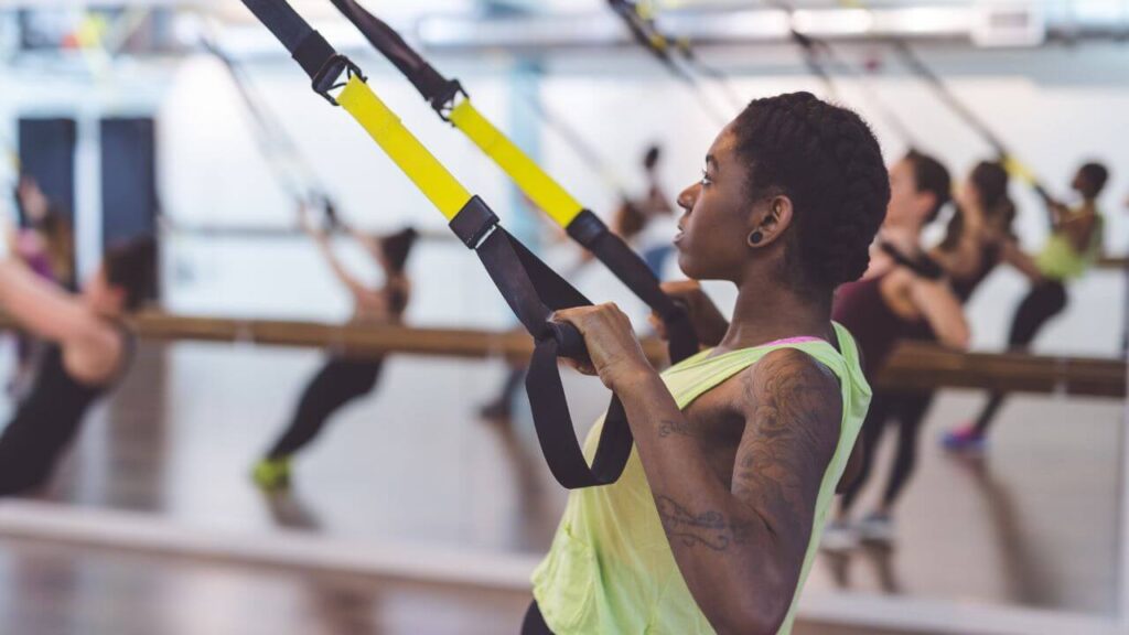 Woman performs TRX rows