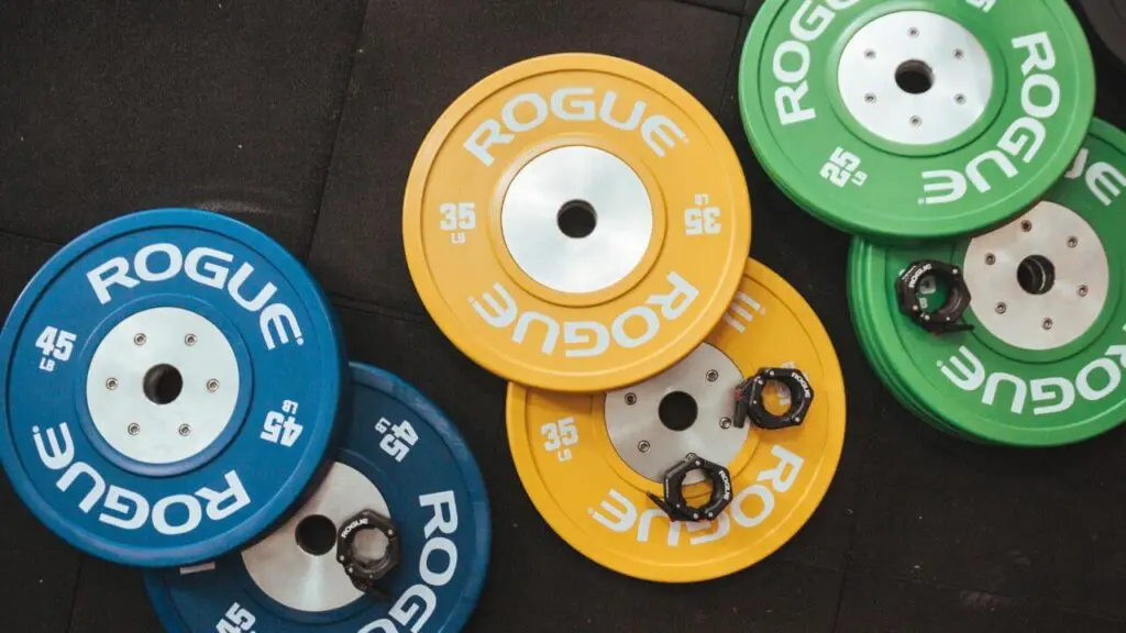 Olympic weight plates lying on the floor.