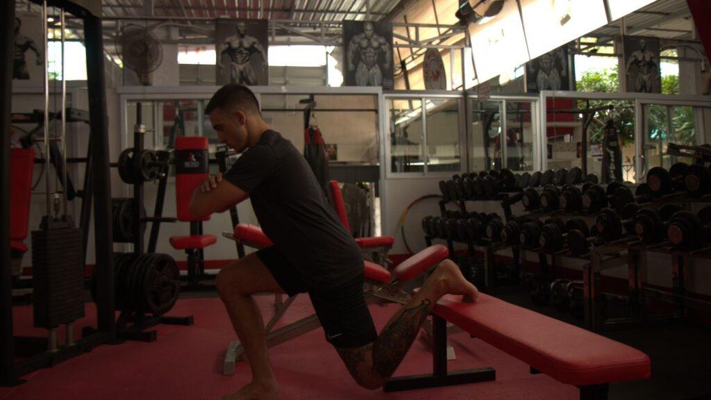 Man doing rear foot elevated split squats