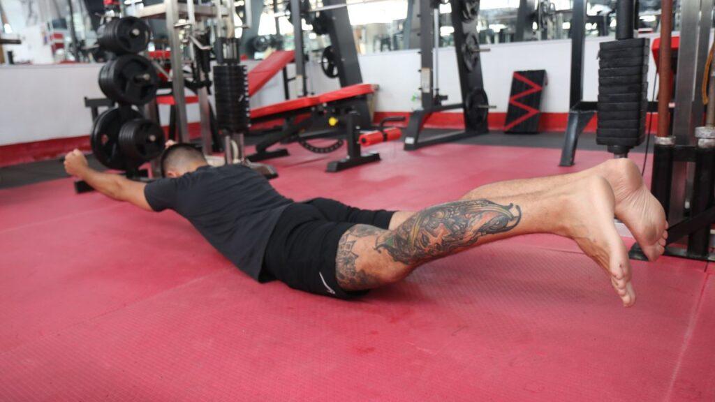 Man doing superman bodyweight exercise