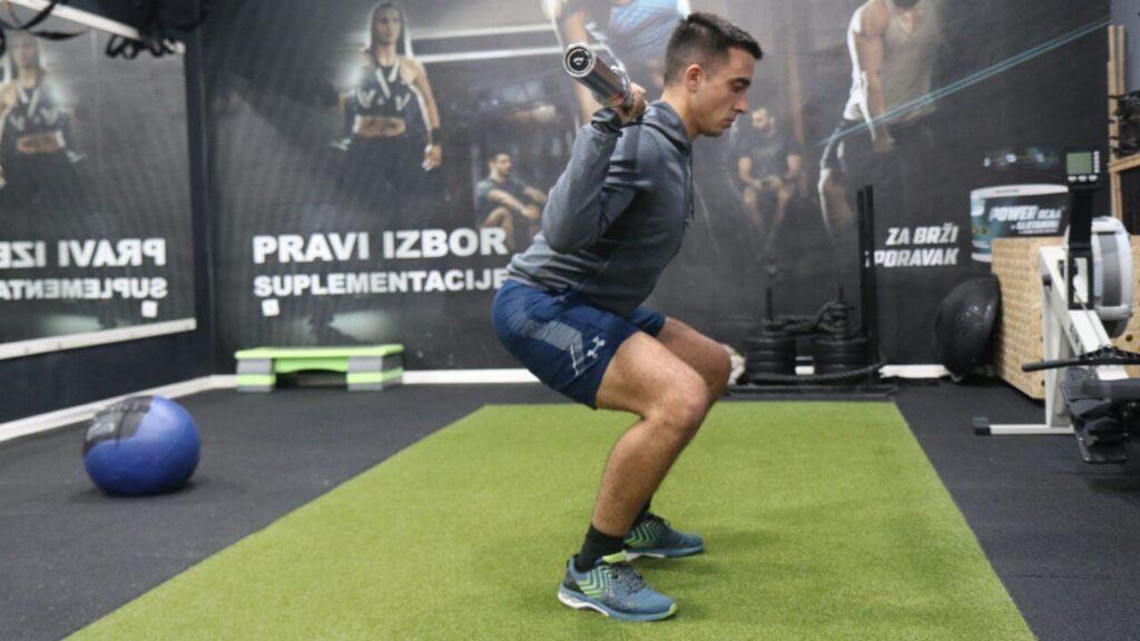 Radomir performs back squats.