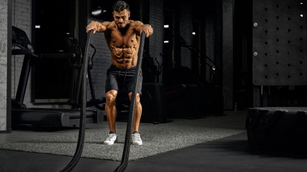 Man does bilateral battle rope exercise