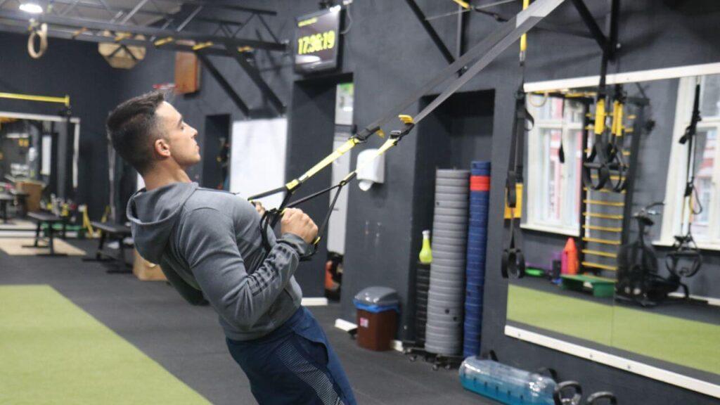 Radomir performs Inverted TRX rows.