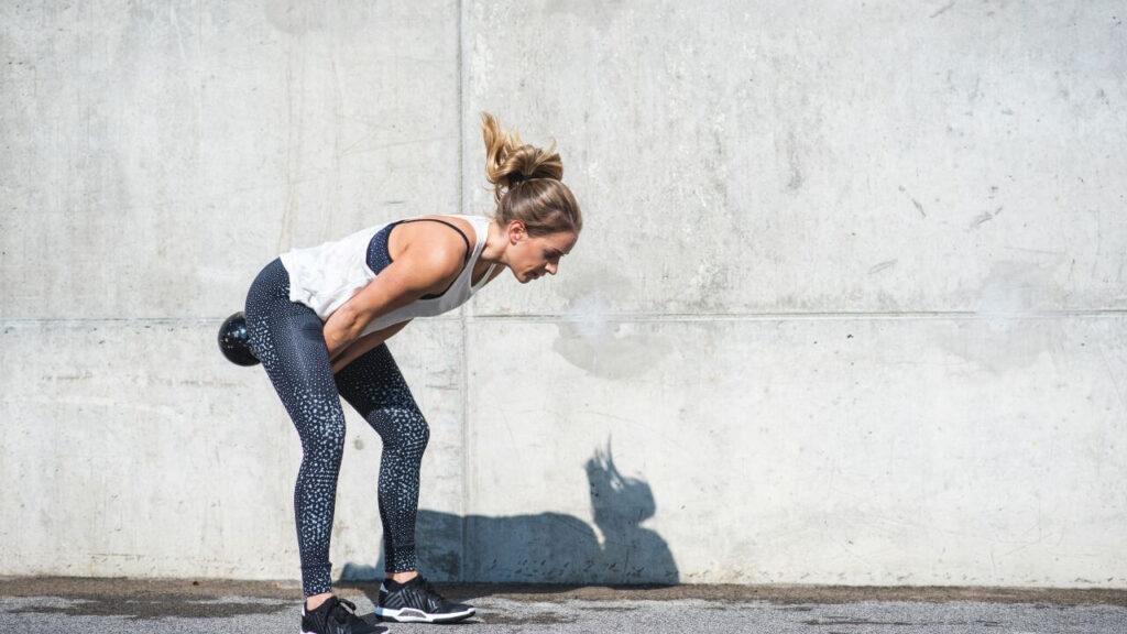 woman performing kettlebell swings