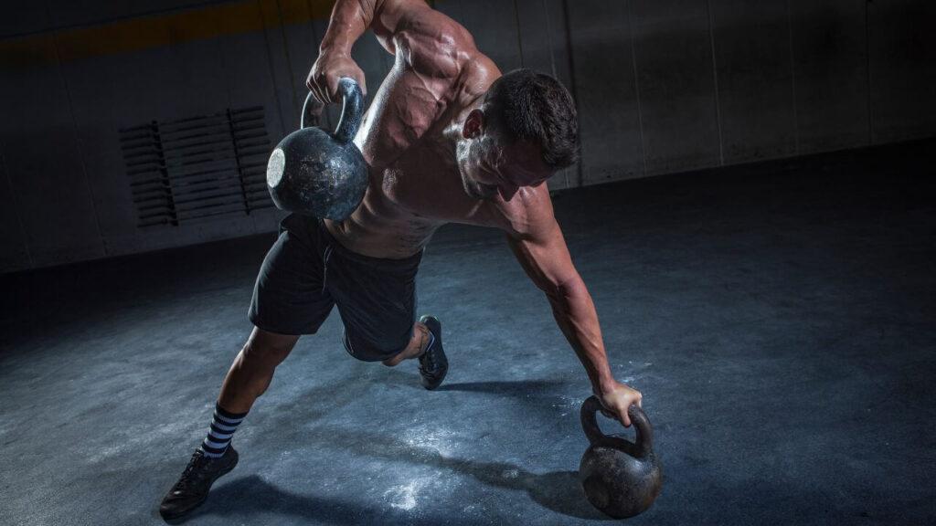 Man performs kettlebell rows