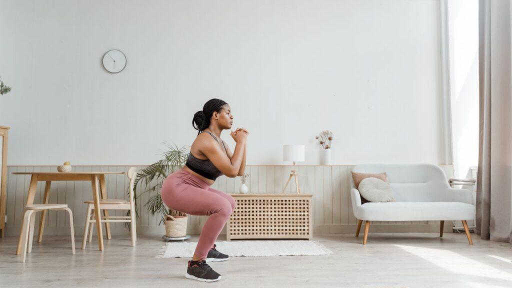 Woman demonstrates squatting movement pattern.