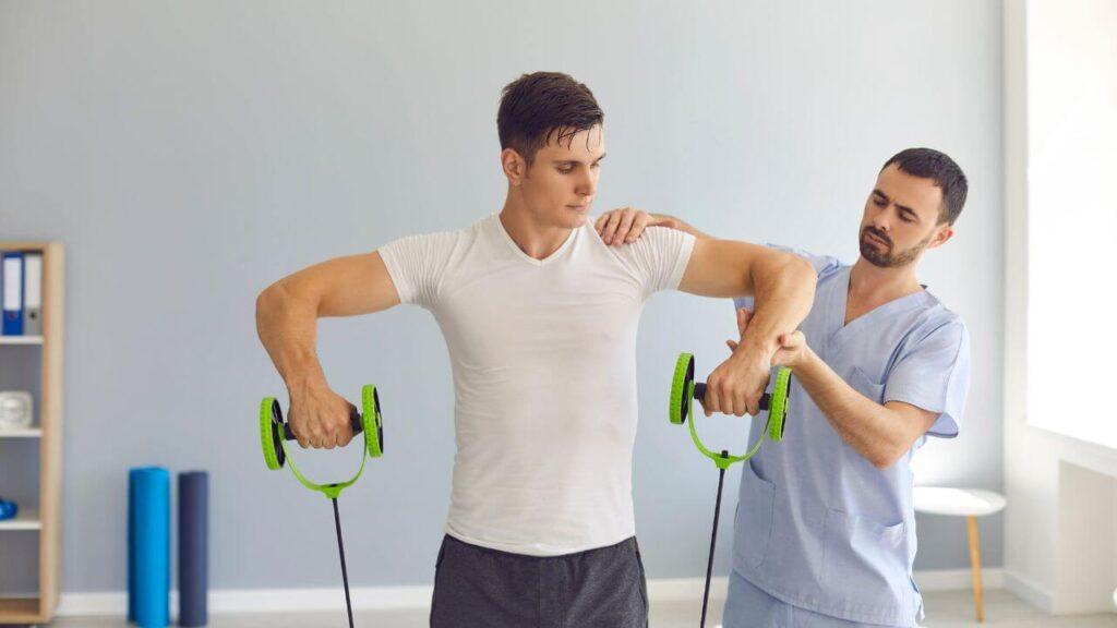 A man exercises with resistance bands with the help of a certified physician.