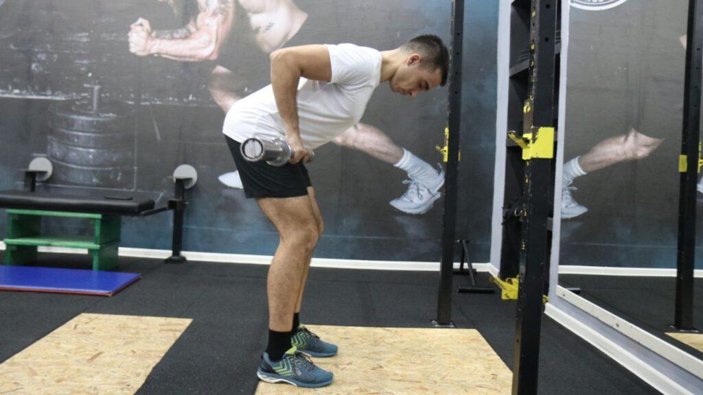 Coach Radomir performs barbell bent-over rows.