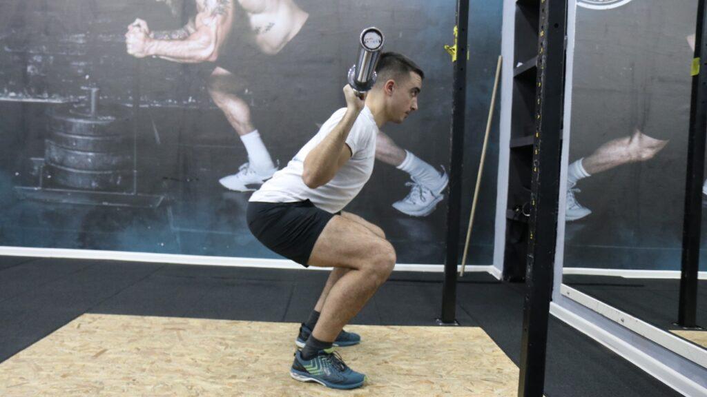 Radomir performs barbell squats.