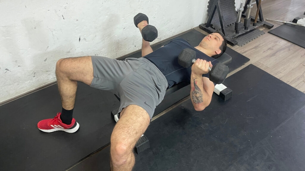 Vanja lies down on the flat bench on his back.